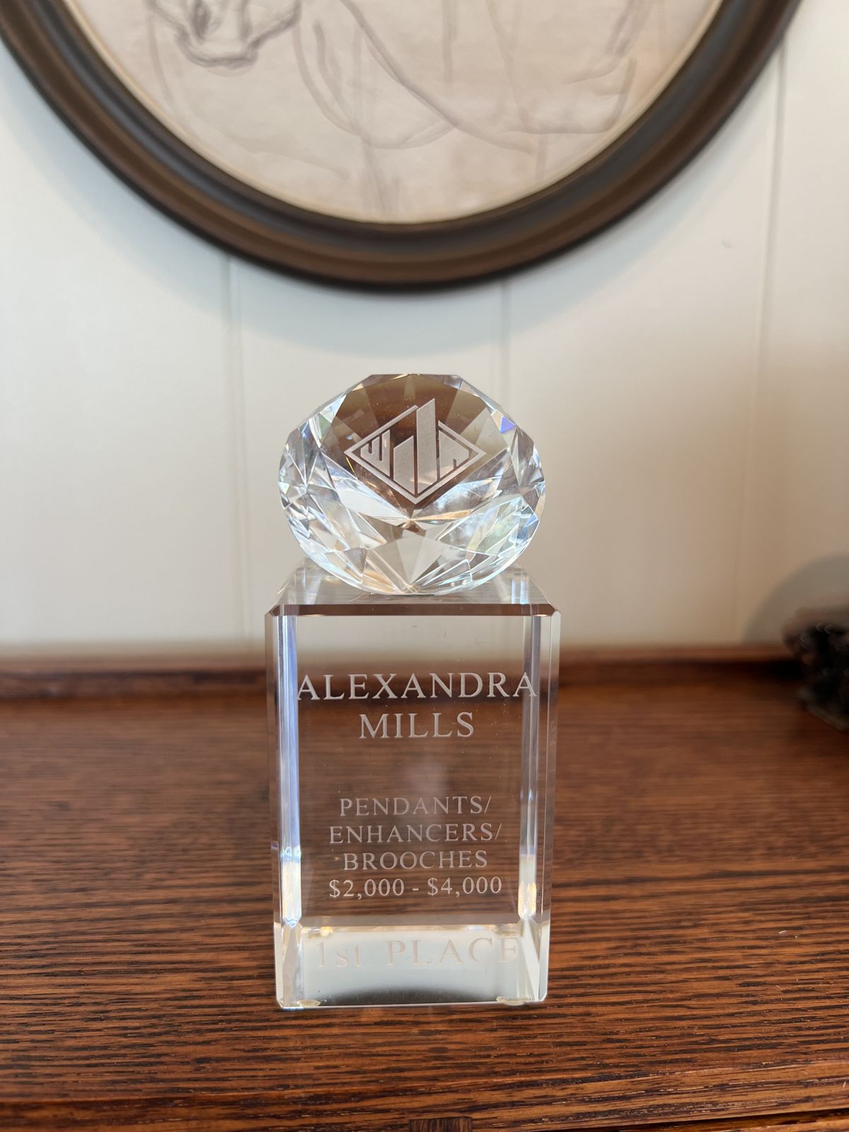 A first place crystal trophy engraved for Alexandra Mills
