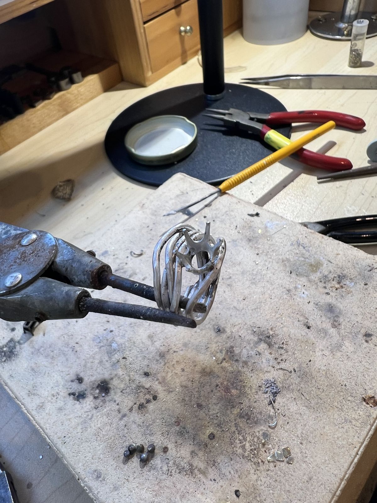 A soldering station with a ring held in a third hand tool