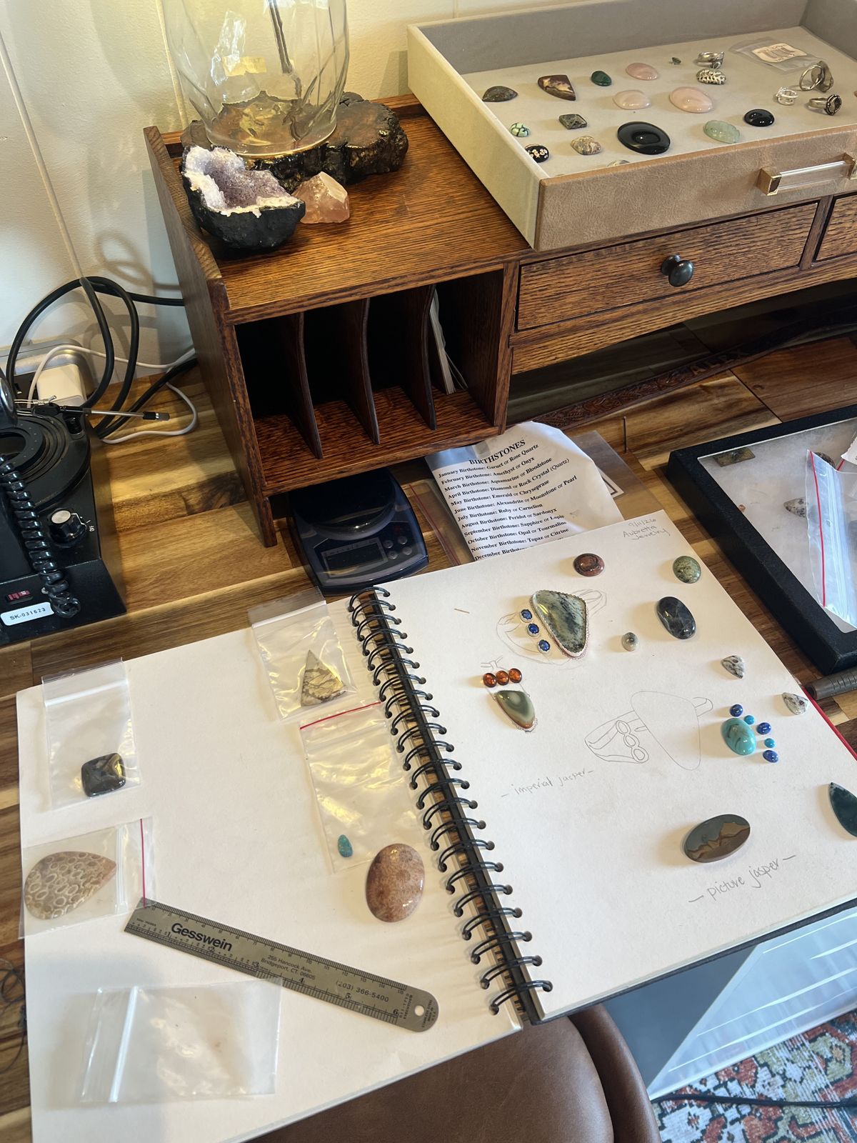 The studio bench with a stone drawer, sketchbook, and lamp